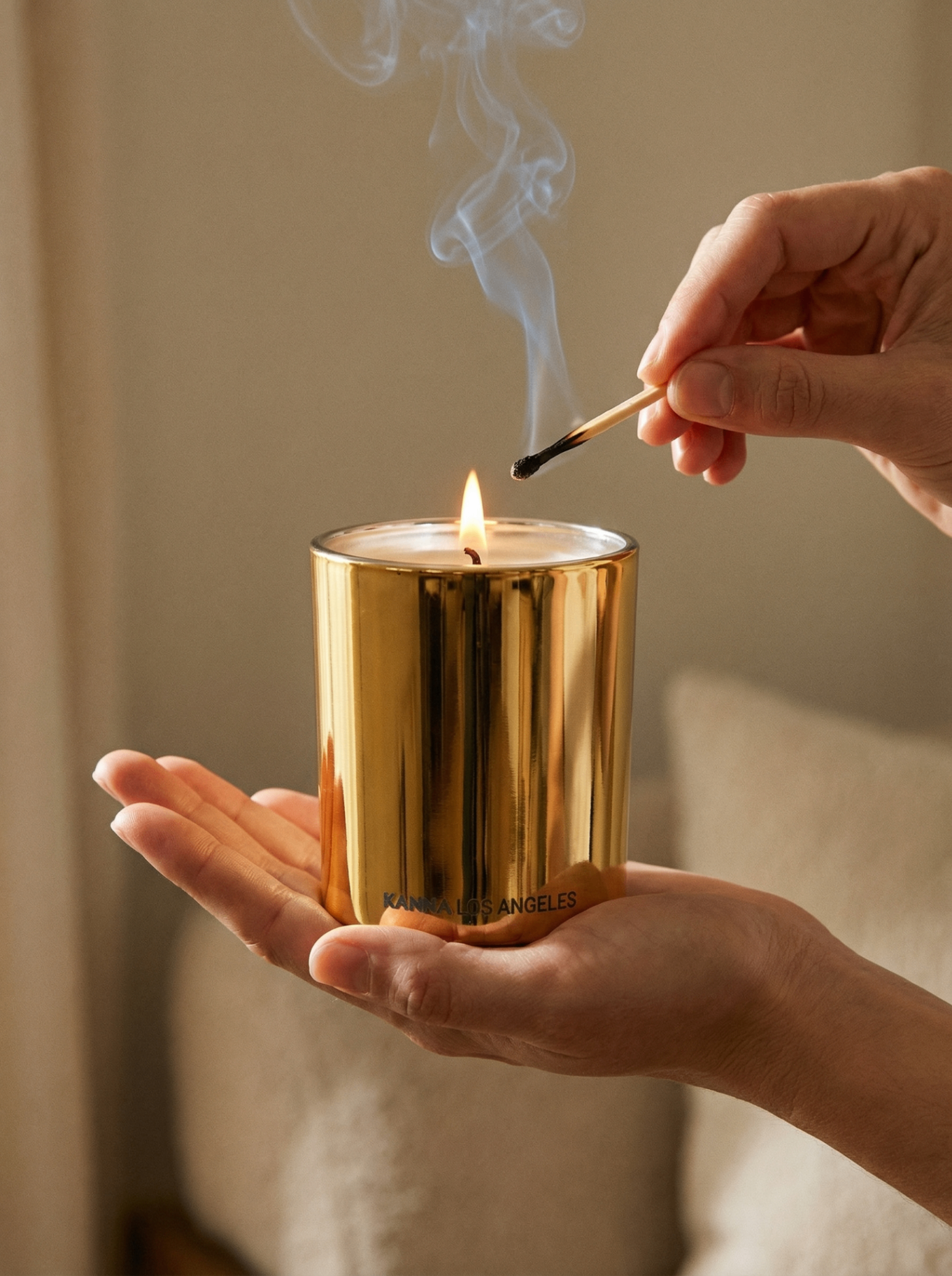 A hand lighting a KANNA candle